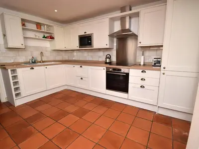 a kitchen with white cabinets and a tile floor at 2 Bed in Keswick oc-sz279 in Keswick
