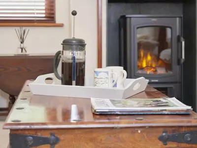 a table with a coffee maker and a fireplace at 2 Bed in Keswick oc-sz279 in Keswick