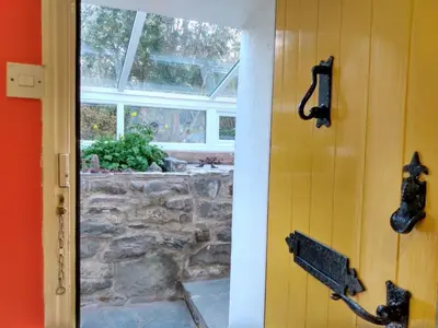 a door to a patio with a stone wall at 3 Bed in Keswick oc-sz533 in Braithwaite