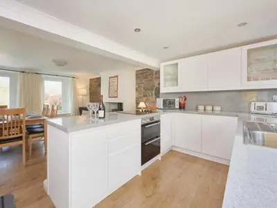a kitchen with white cabinets and a dining room at 3 Bed in Keswick oc-sz533 in Braithwaite