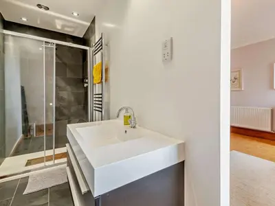 a white bathroom with a sink and a shower at 4 Bed in Cockermouth oc-sz037 in Cockermouth