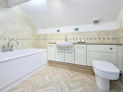 a bathroom with a sink and a tub and a toilet at 2 Bed in Cockermouth oc-sz588 in Buttermere
