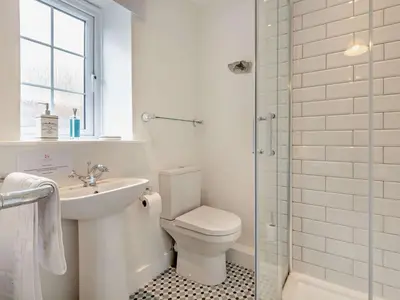 a bathroom with a toilet and a sink and a shower at 3 Bed in Braithwaite SZ174 in Braithwaite
