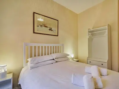 a bedroom with a white bed with two towels on it at 4 Bed in Ambleside oc-85294 in Grasmere