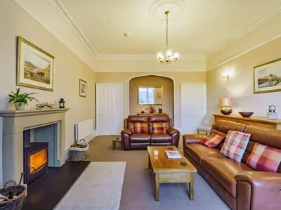 a living room with a couch and a fireplace at 4 Bed in Ambleside oc-85294 in Grasmere