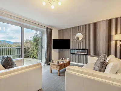 a living room with a couch and a large window at 2 Bed in Keswick 86001 in Keswick