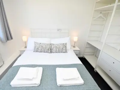a bedroom with a white bed and two white shelves at 4 Bed in Seascale oc-85807 in Gosforth