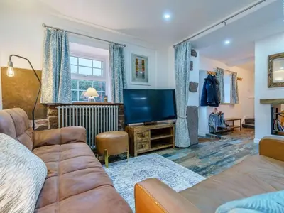 a living room with a couch and a flat screen tv at 4 Bed in Seascale oc-85807 in Gosforth