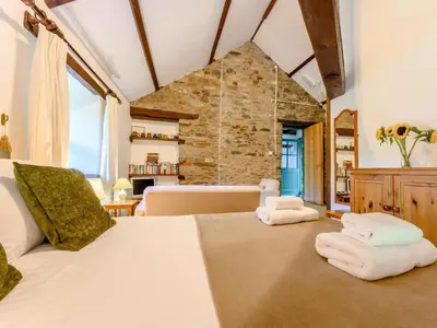 a bedroom with a large bed with towels on it at 1 Bed in Penrith oc-88201 in Mosedale