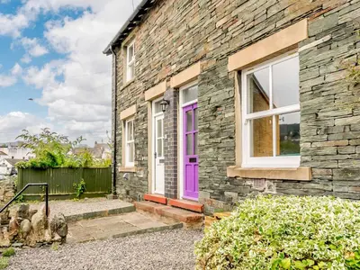a brick house with a purple door at 2 Bed in Keswick 88864 in Keswick
