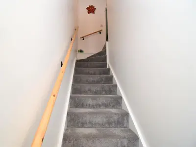 a staircase in a house with white walls and gray stairs at 2 Bed in Keswick 88864 in Keswick