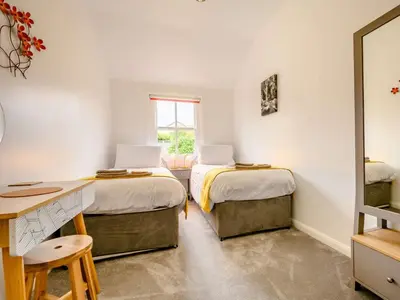 a room with two beds and a desk and a window at 2 Bed in Keswick 88864 in Keswick