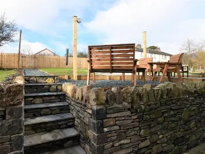 two benches sitting on top of a stone wall at 2 Bed in Keswick 88864 in Keswick
