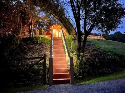 a set of stairs leading up to a house with a gate at 1 Bed in Ennerdale Bridge 88672 in Frizington