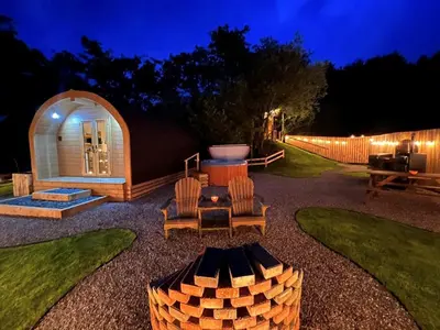 a backyard with a tent and a grill at night at 1 Bed in Ennerdale Bridge 88672 in Frizington