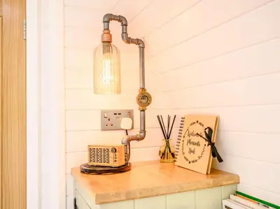 a table with a lamp and a radio on it at 1 Bed in Ennerdale Bridge 88672 in Frizington