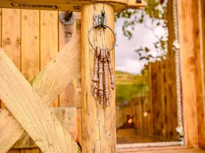 a bunch of prayersticks hanging on a wooden post at 1 Bed in Ennerdale Bridge 88672 in Frizington