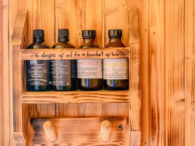 a wooden shelf with four bottles of alcohol on it at 1 Bed in Ennerdale Bridge 88672 in Frizington