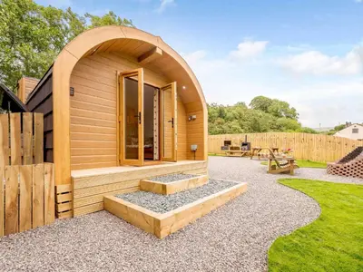 a small house with an archway in a garden at 1 Bed in Ennerdale Bridge 88672 in Frizington