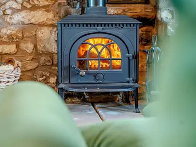 a blue stove with a fire inside of it at 5 Bed in Wigton oc-89496 in Torpenhow