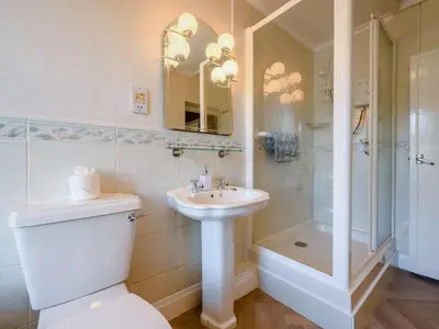 a bathroom with a toilet and a sink and a shower at 3 Bed in Aspatria 89139 in Aspatria
