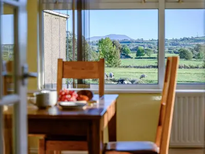 a table with a bowl of fruit and a plate of fruit on it at 3 Bed in Aspatria 89139 in Aspatria