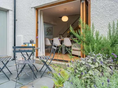 a patio with chairs and a table and some plants at 2 Bed in Keswick oc-89257 in Keswick
