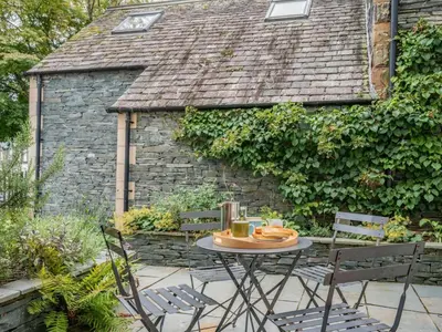 a table and chairs in front of a building at 2 Bed in Keswick oc-89257 in Keswick
