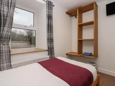a bedroom with a bed and a window at 8 Little Mell Fell in Penrith