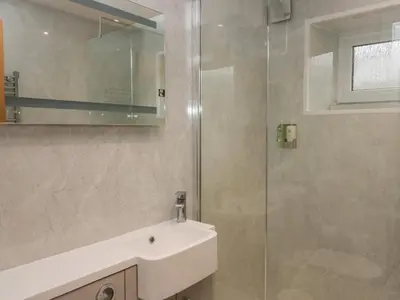 a bathroom with a sink and a glass shower at 8 Little Mell Fell in Penrith