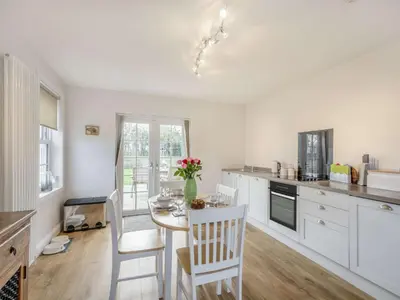 a kitchen with a table and chairs in a kitchen at 2 Bed in Ayr 90039 in Ayr