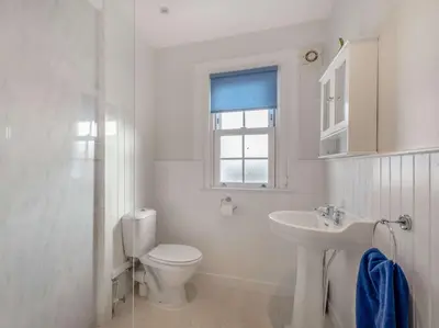 a white bathroom with a toilet and a sink at 2 Bed in Ayr 90039 in Ayr