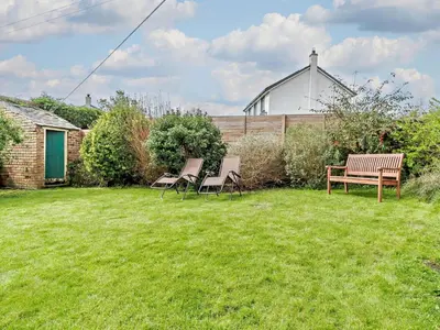 a group of chairs and a bench in a yard at 3 Bed in Egremont oc-90050 in Hale
