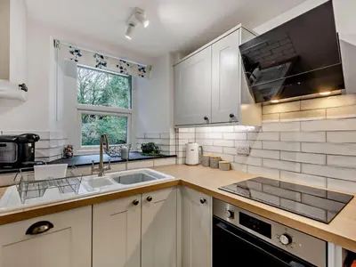 a kitchen with white cabinets and a sink at 2 Bed in Keswick oc-90064 in Threlkeld