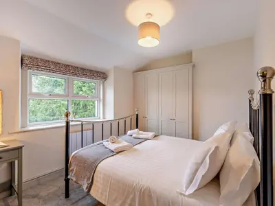 a bedroom with a bed with white sheets and a window at 2 Bed in Keswick oc-90064 in Threlkeld