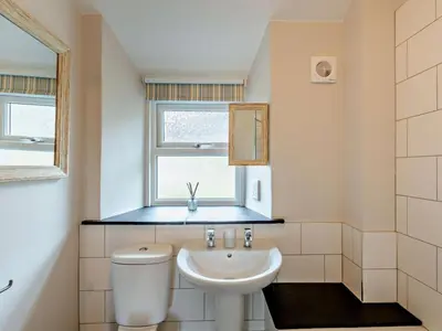a bathroom with a sink and a toilet and a window at 2 Bed in Keswick oc-90064 in Threlkeld