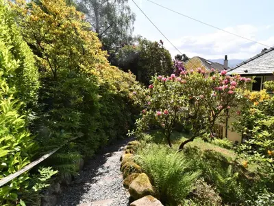 a garden with pink flowers and bushes at 3 Bed in Keswick oc-90266 in Applethwaite