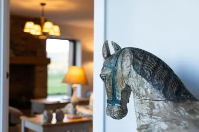 a statue of a horse head hanging on a wall at Sheepfold Barn in Penruddock