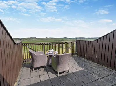 a patio with two chairs and a table on a balcony at 1 Bed in Ullswater 90300 in Penruddock