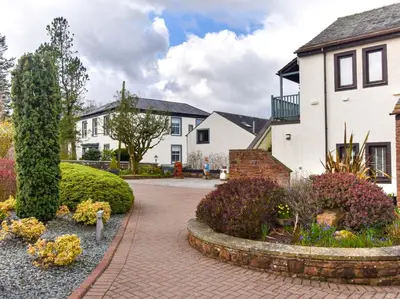 a house with a brick walkway in front of a yard at 1 Bed in Ullswater 90300 in Penruddock
