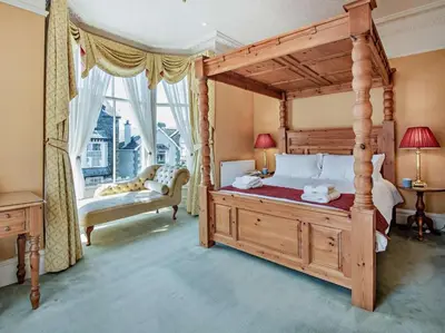 a bedroom with a canopy bed and a large window at 6 Bed in Keswick oc-90333 in Keswick