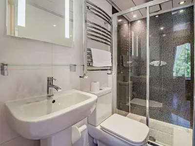 a white bathroom with a sink and a shower at 6 Bed in Keswick oc-90333 in Keswick