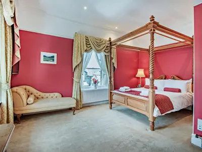 a bedroom with a canopy bed and a window at 6 Bed in Keswick oc-90333 in Keswick