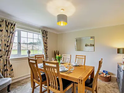 a dining room with a wooden table and chairs at 3 Bed in Dovenby 90920 in Tallentire