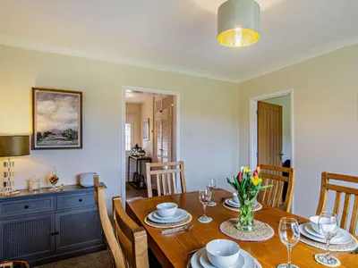 a dining room with a wooden table and chairs at 3 Bed in Dovenby 90920 in Tallentire