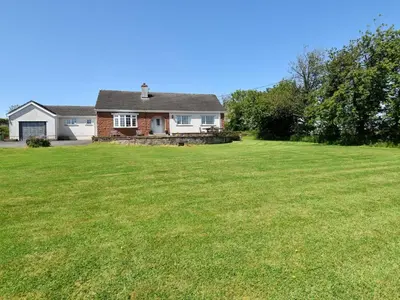 a house with a large lawn in front of it at 3 Bed in Dovenby 90920 in Tallentire