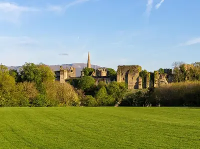 a green field with a castle in the background at 3 Bed in Dovenby 90920 in Tallentire