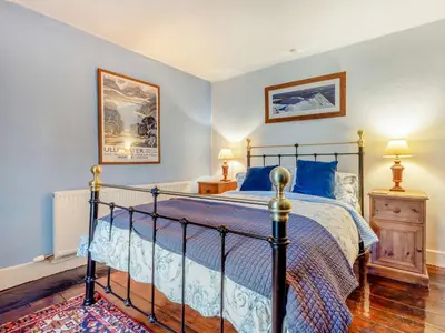 a bedroom with a bed with blue walls at 2 Bed in Glenridding 90874 in Glenridding