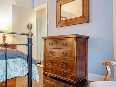 a bedroom with a wooden dresser and a mirror at 2 Bed in Glenridding 90874 in Glenridding
