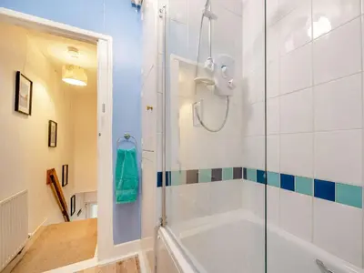 a bathroom with a shower and a tub at 2 Bed in Glenridding 90874 in Glenridding